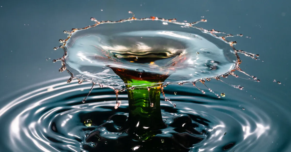 cost of ecowater water softener with water splash crown and green liquid column detail macro photos.